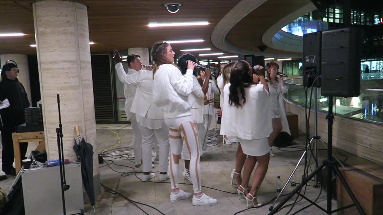 Urban Voices Collective singers performing beside the Broadgate ice rink in 2016