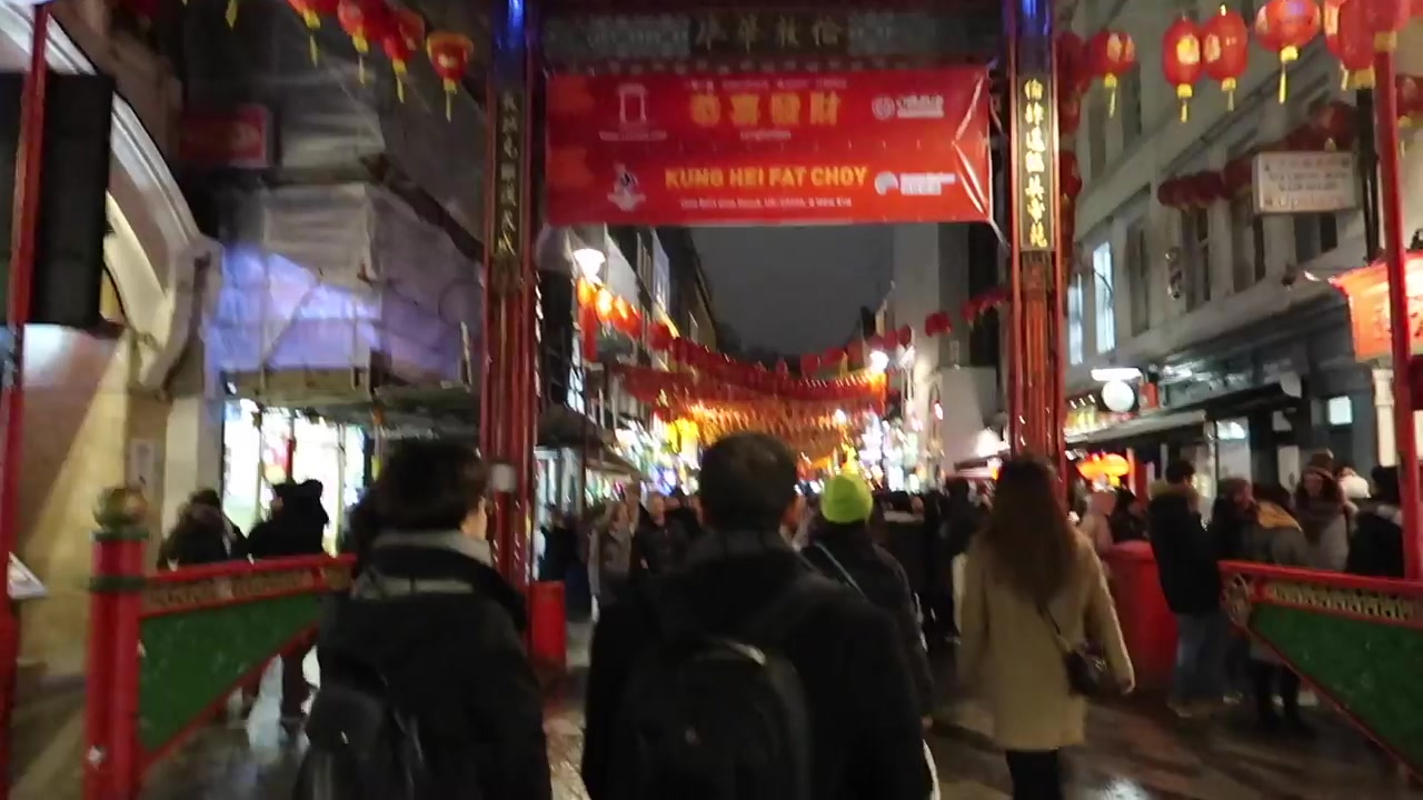The Chinatown gate and crowds beneath red lanterns.