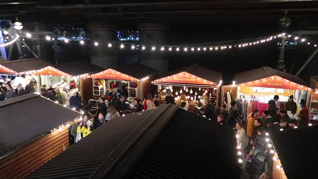 Illuminated wooden stalls in the Christmas market montage.