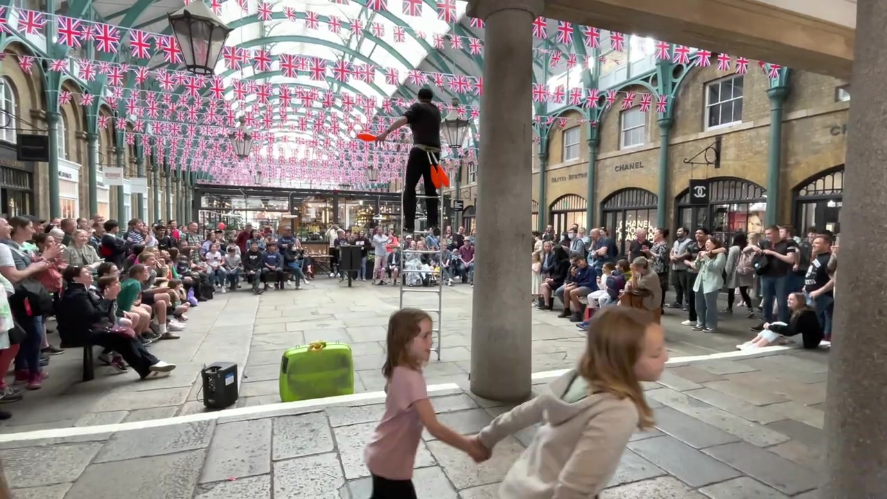 Street performer entertaining a crowd in Covent Garden in June 2022