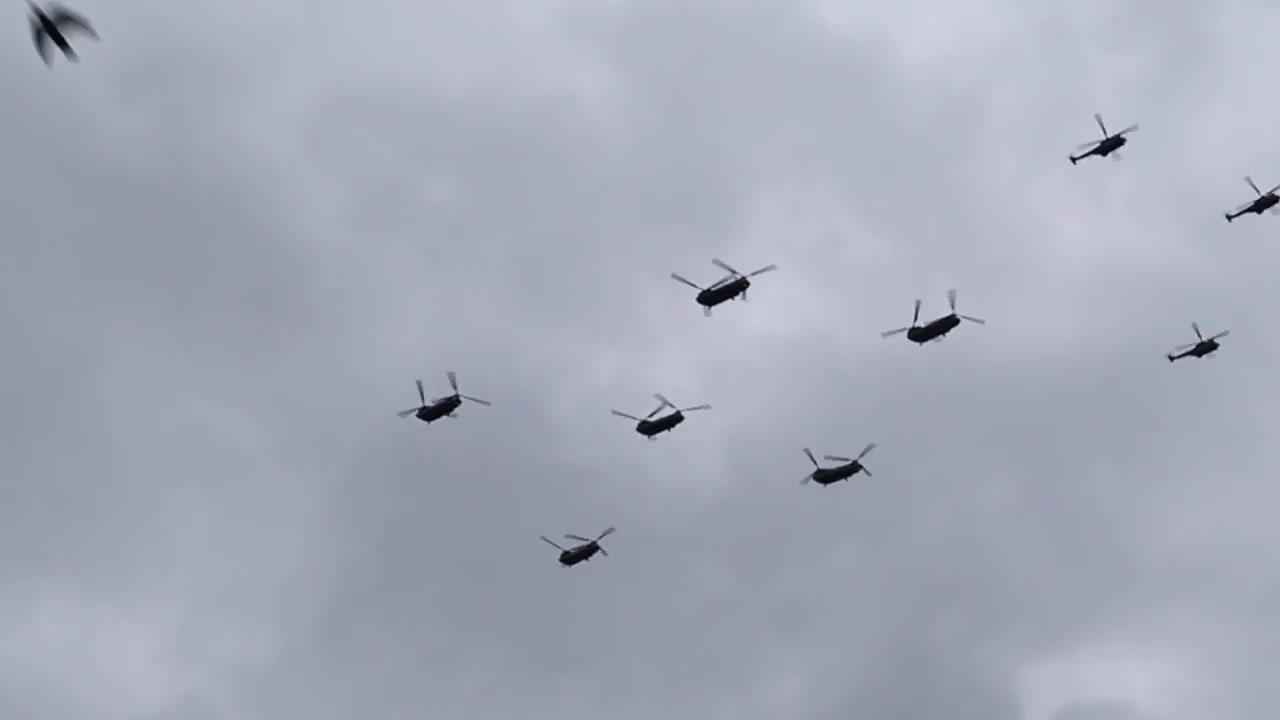 RAF helicopters flying in formation during the RAF100 centenary flypast