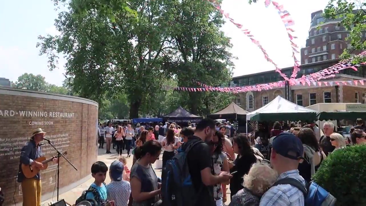 Crowds and food stalls at Duke of York Square Food Market in Chelsea
