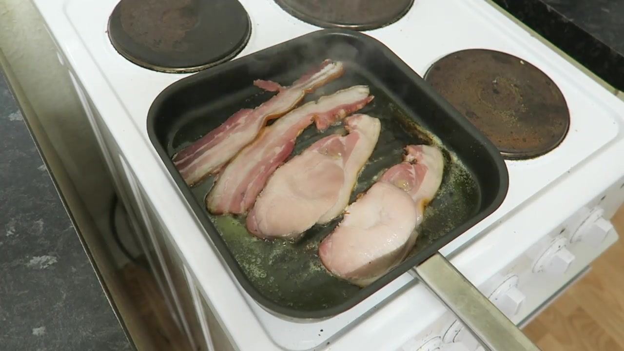 Back bacon and streaky bacon cooking together in a griddle pan