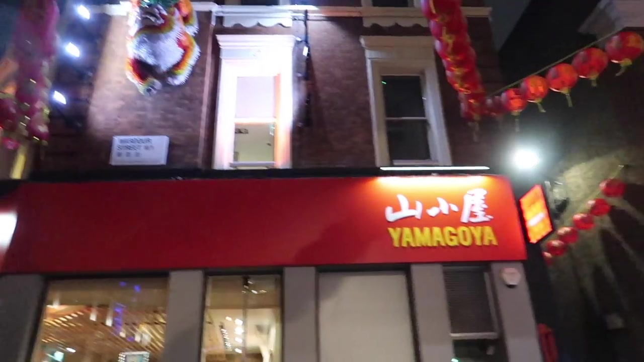 Chinatown restaurant lights and red lanterns after dark.