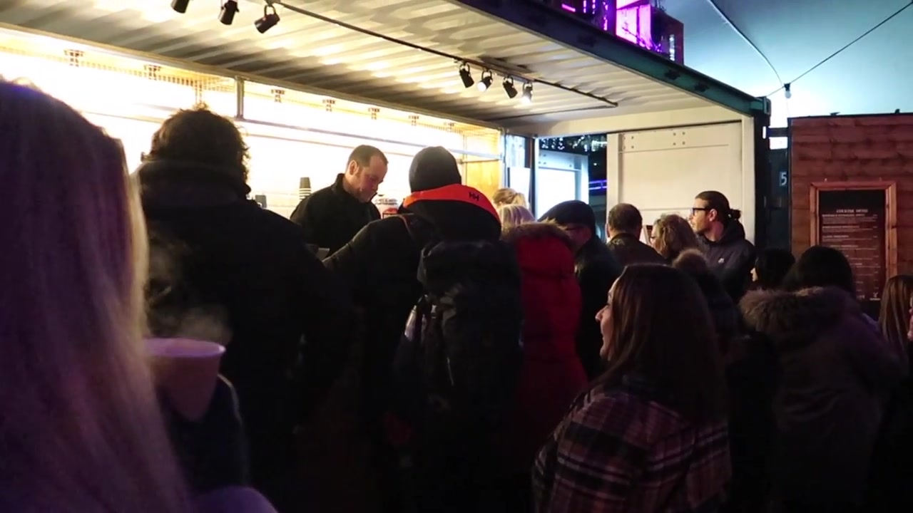 Visitors gathered at a brightly lit bar during the London Bridge market visit.