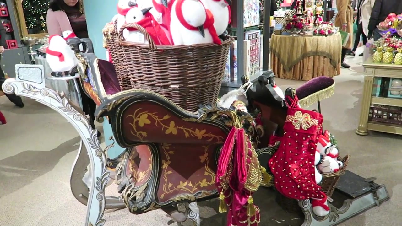 Decorated sleigh filled with Christmas gifts and stockings at Fortnum & Mason