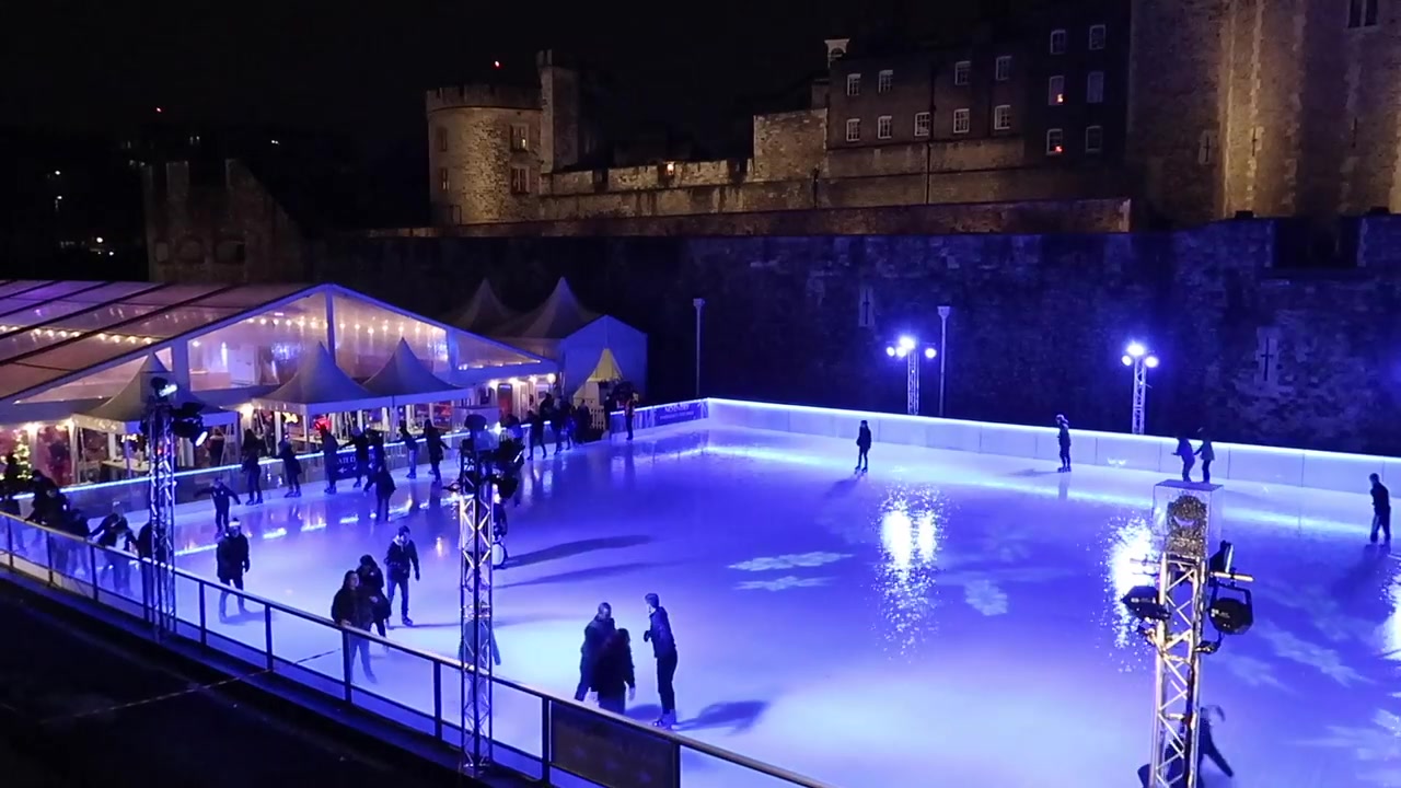 Skaters on the rain-soaked ice in the Tower of London moat.
