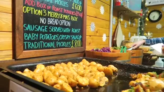 Street food menu and roast potatoes at the Southbank Christmas Market