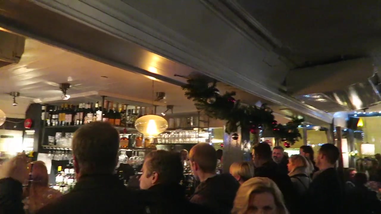 Christmas crowd gathered inside a pub near Shepherd Market in Mayfair