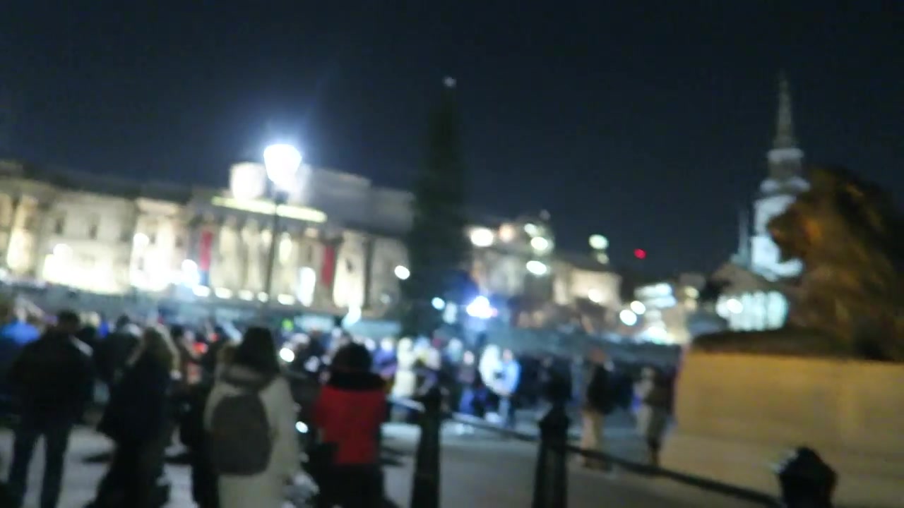 The National Gallery illuminated behind the crowd at the Trafalgar Square Christmas tree ceremony