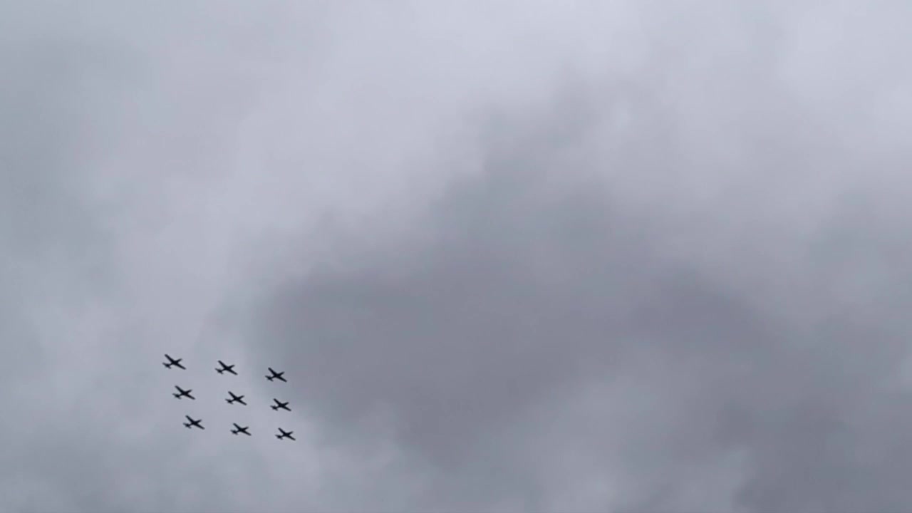 Nine RAF aircraft flying in formation over London during the centenary flypast