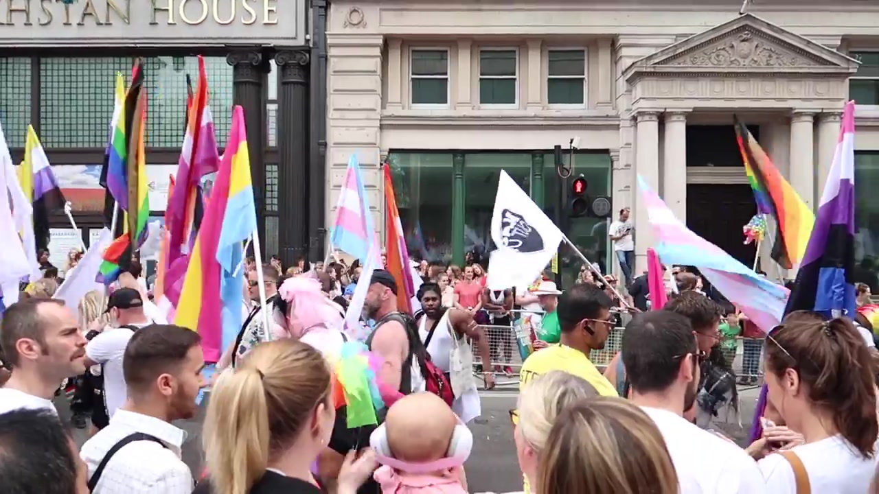 Rainbow flags above the Pride parade crowd.