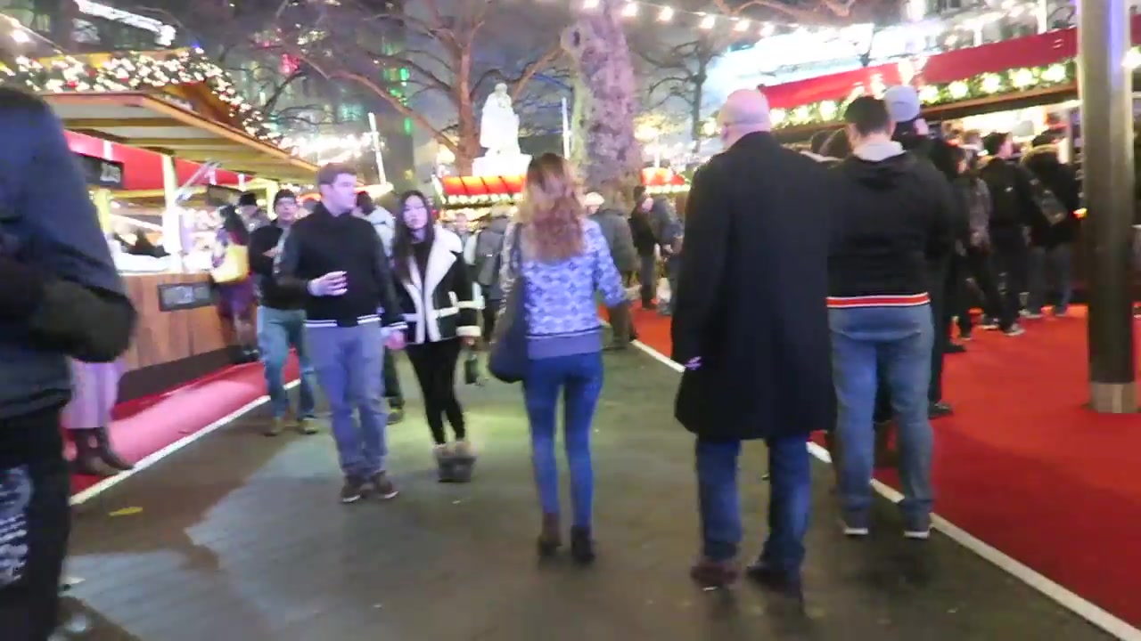 Visitors walking among wooden stalls at the Southbank Christmas market in London in 2016
