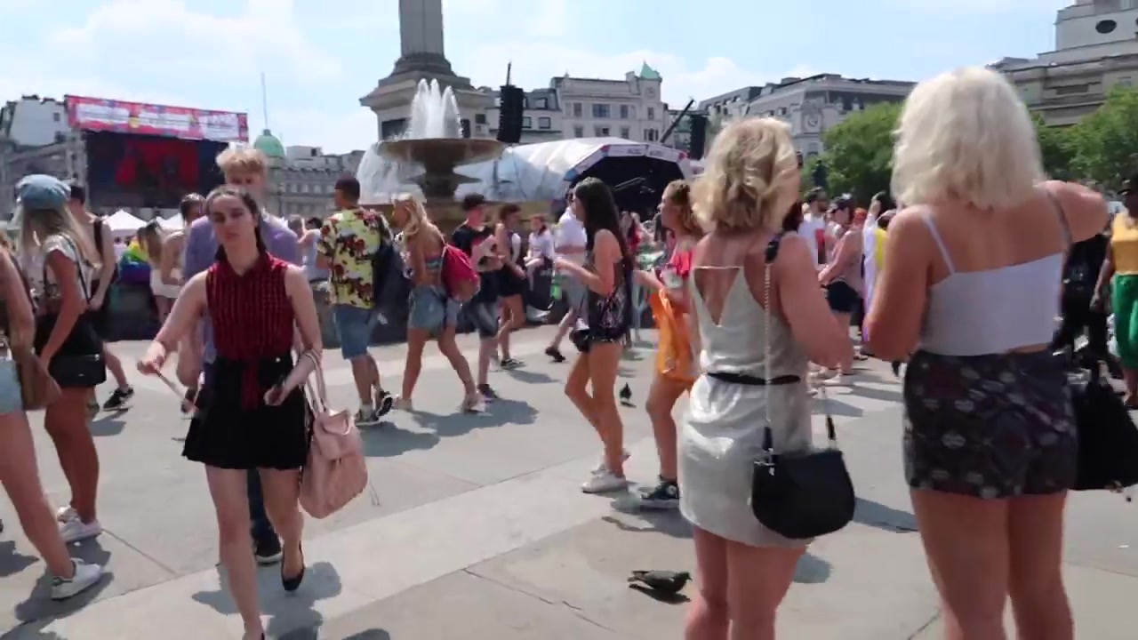 Pride attendees walking towards the Trafalgar Square stage in London