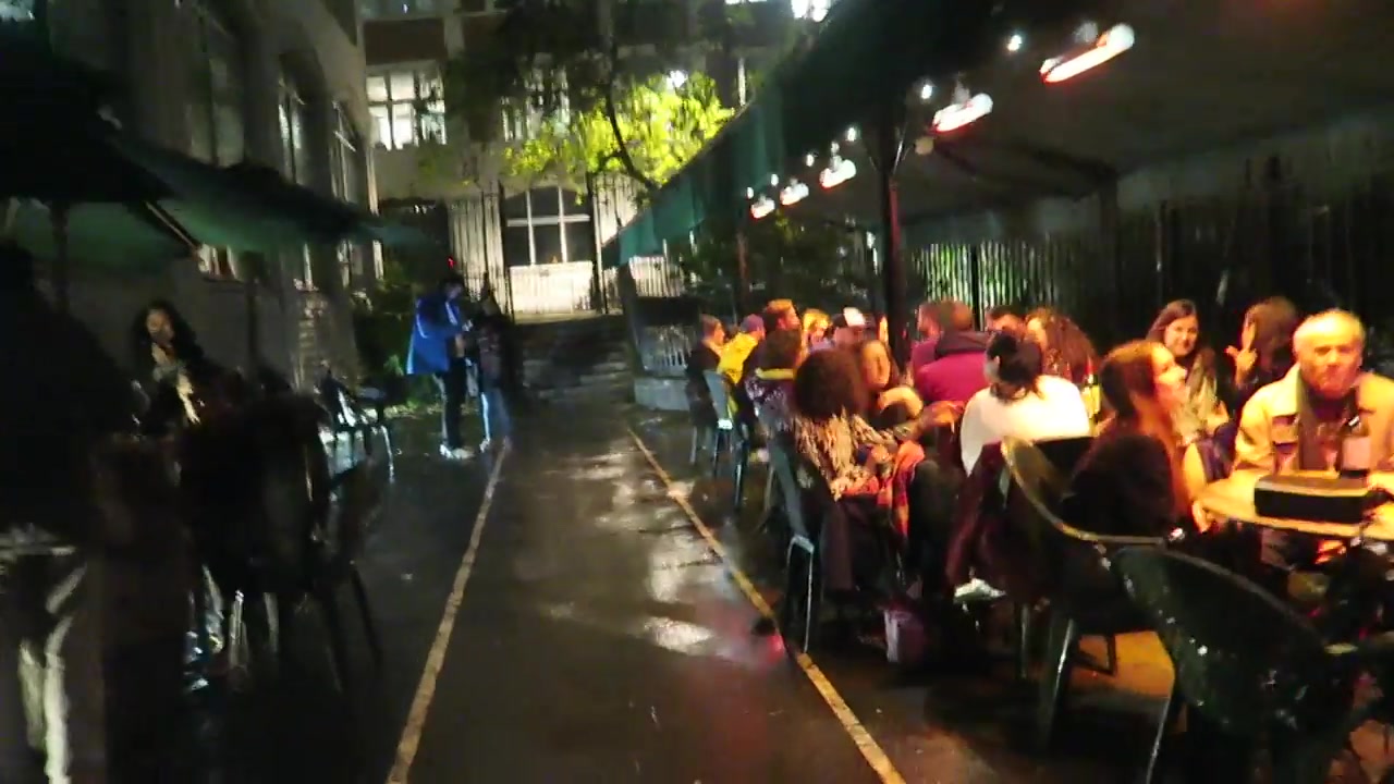 Diners seated beneath heaters on Gordon’s Wine Bar outdoor terrace after rain