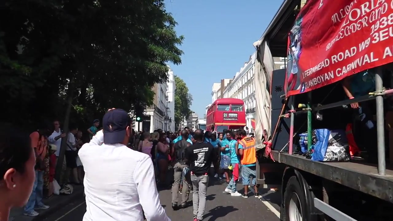 Spectators surrounding the Notting Hill Carnival procession