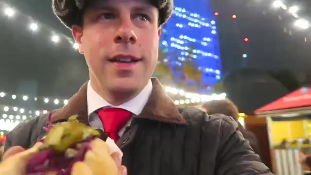 Presenter trying street food at the Southbank Christmas Market in 2016