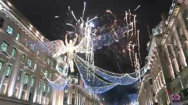 Close view of an illuminated angel with a long light train above Regent Street