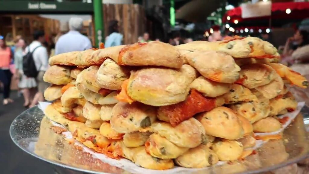 Golden breadsticks stacked at the Bread Ahead market stall.