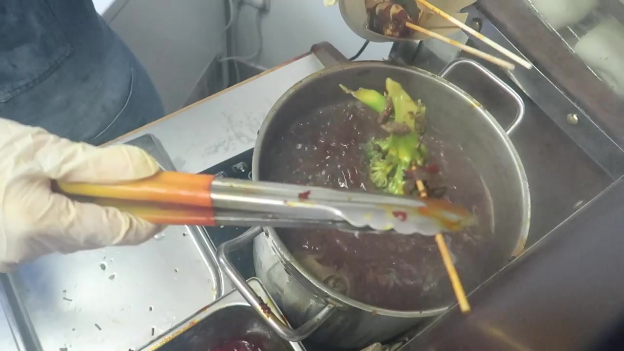 Skewers cooking in the hot pot at Baozi Inn.