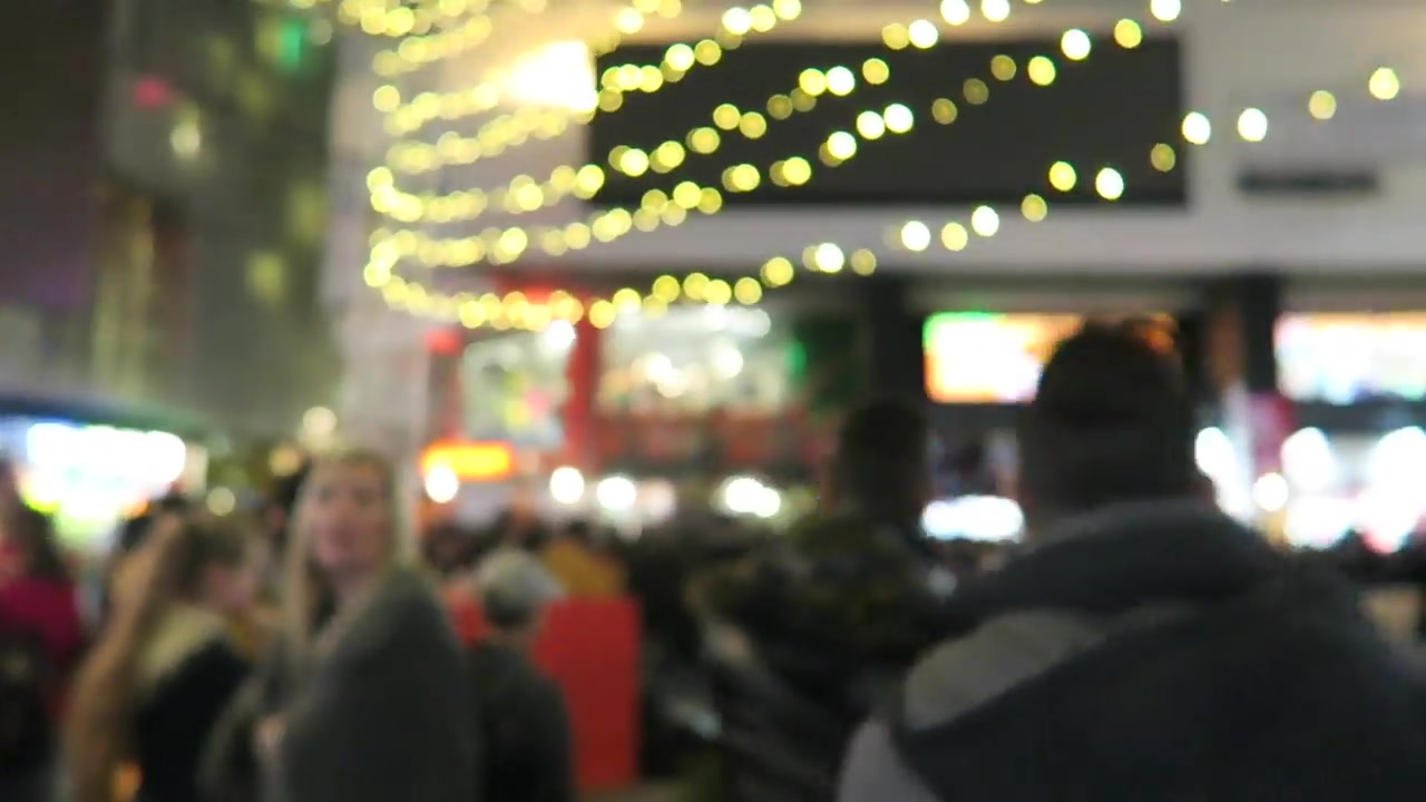 Christmas market entrance and evening visitors in Leicester Square in 2016
