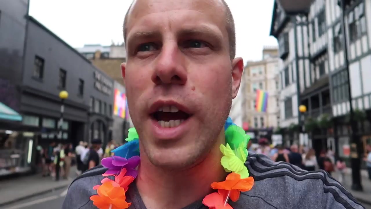 Barry Roberts wearing a rainbow garland near Liberty.