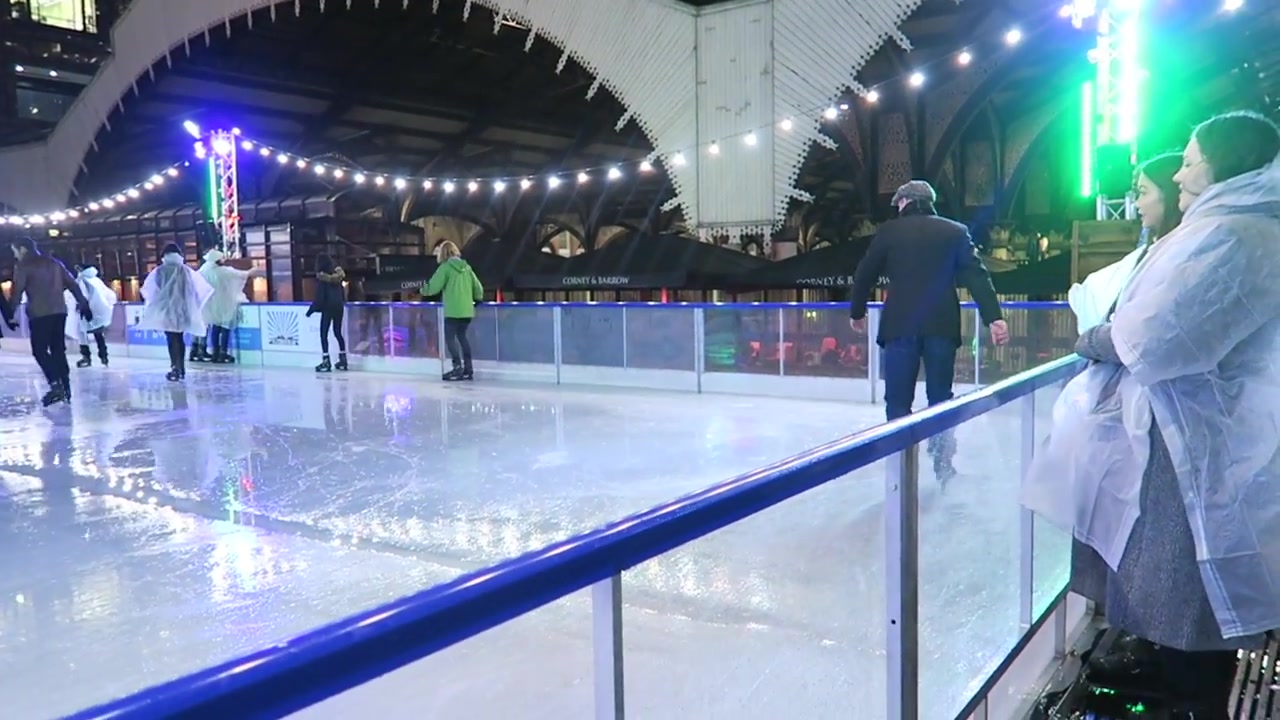 People ice skating beneath the lights at Broadgate Circle in London
