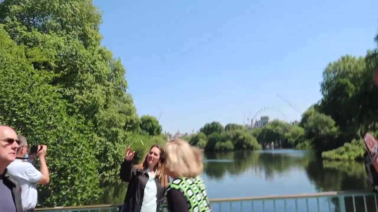 Visitors beside the lake in St James's Park on a sunny day in May 2018