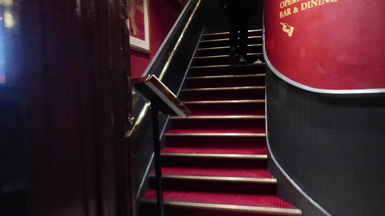 The red-carpeted staircase inside the Chandos.