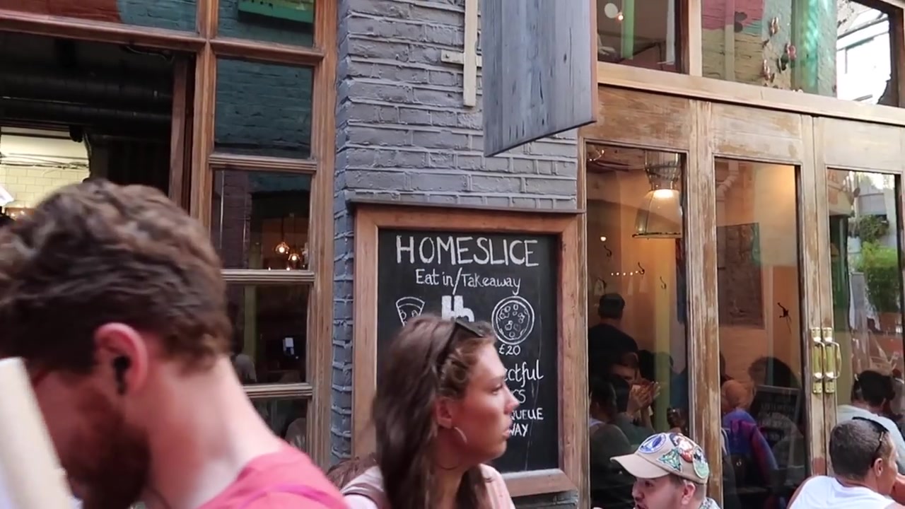 Homeslice restaurant and diners in the Neal's Yard courtyard in summer 2018