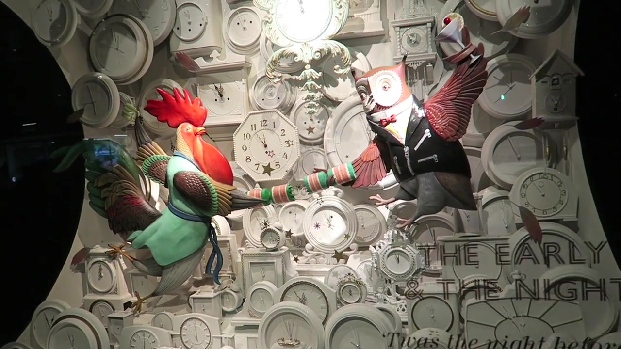 Rooster characters performing against clocks in a Fortnum & Mason Christmas window