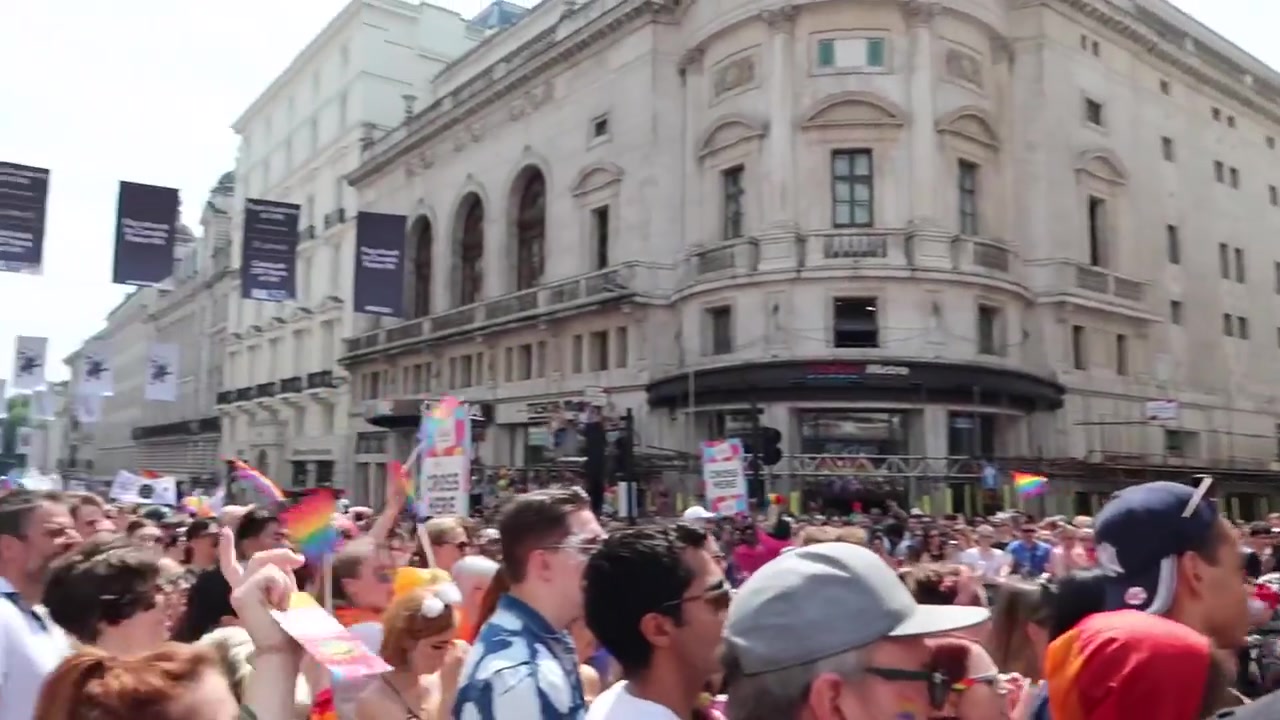 Large Pride in London crowd watching the parade through the West End