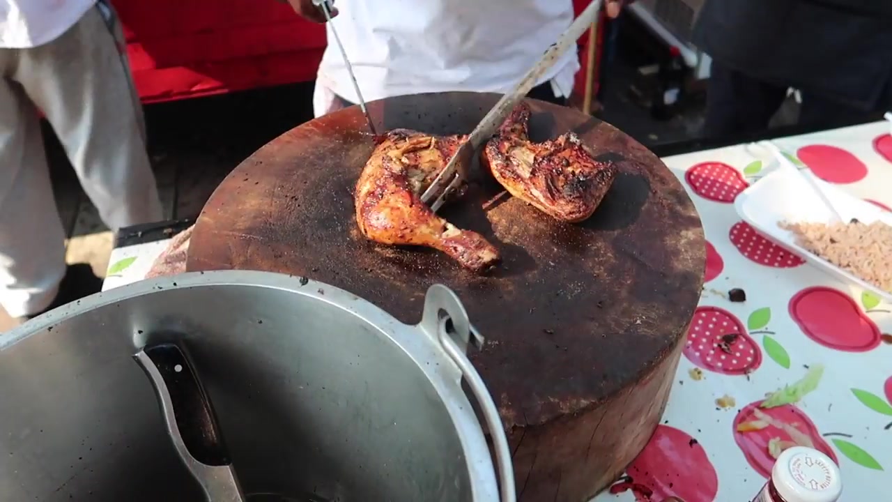 Jerk chicken cooking on a grill at Notting Hill Carnival