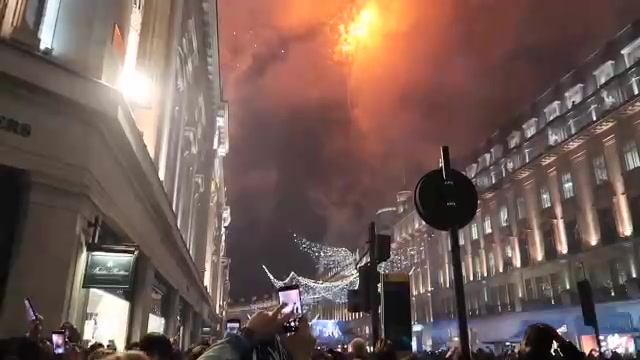 Fireworks and Christmas lights above Regent Street.