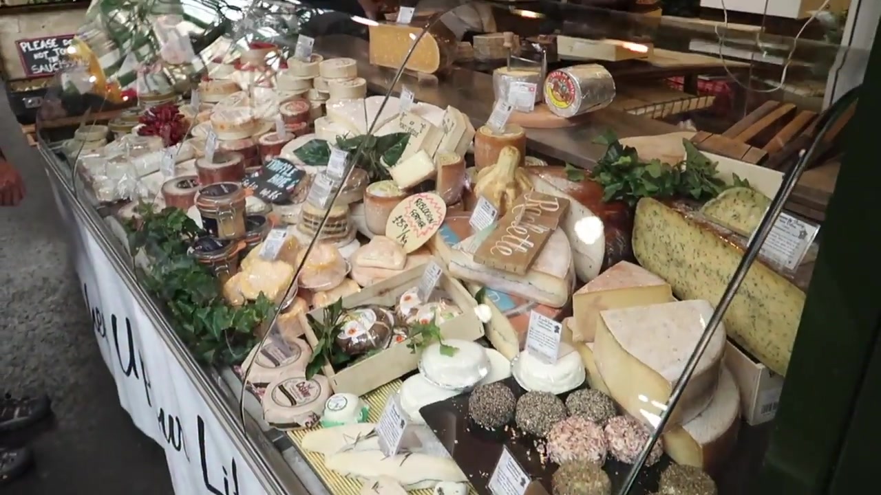 Cheeses displayed on a Borough Market counter.
