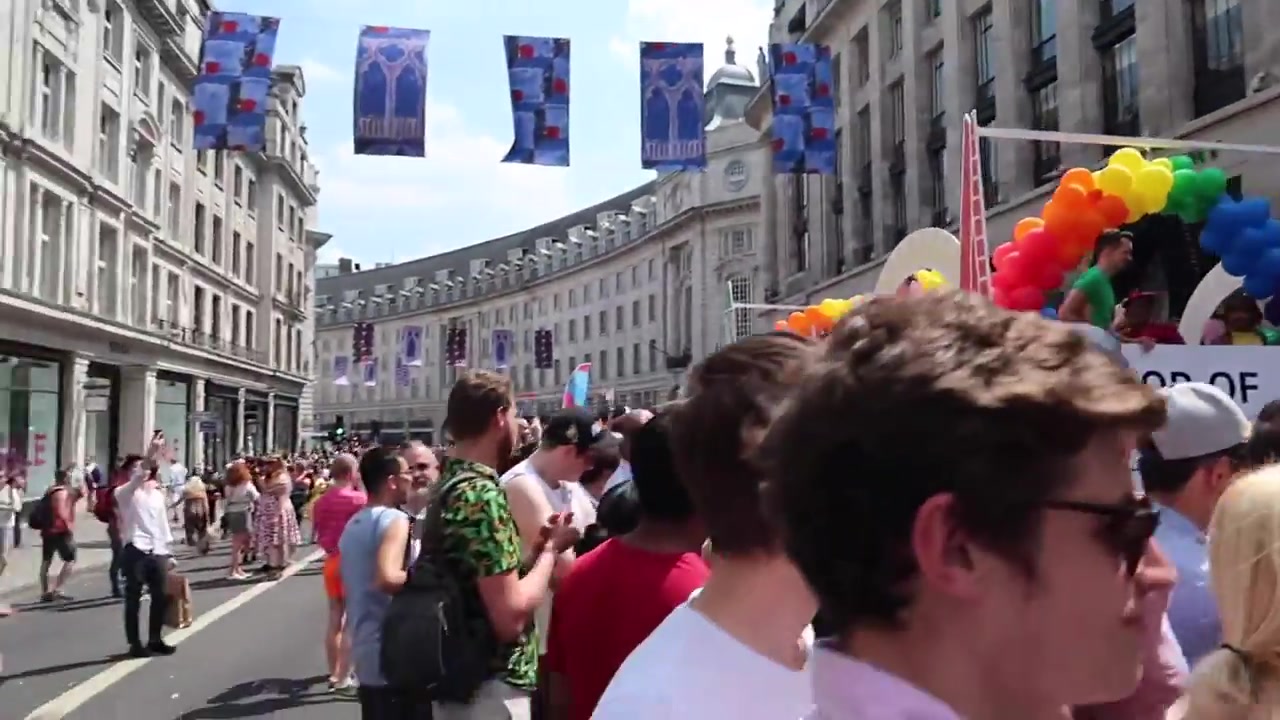 Crowds beneath Pride flags and decorations on Regent Street in London