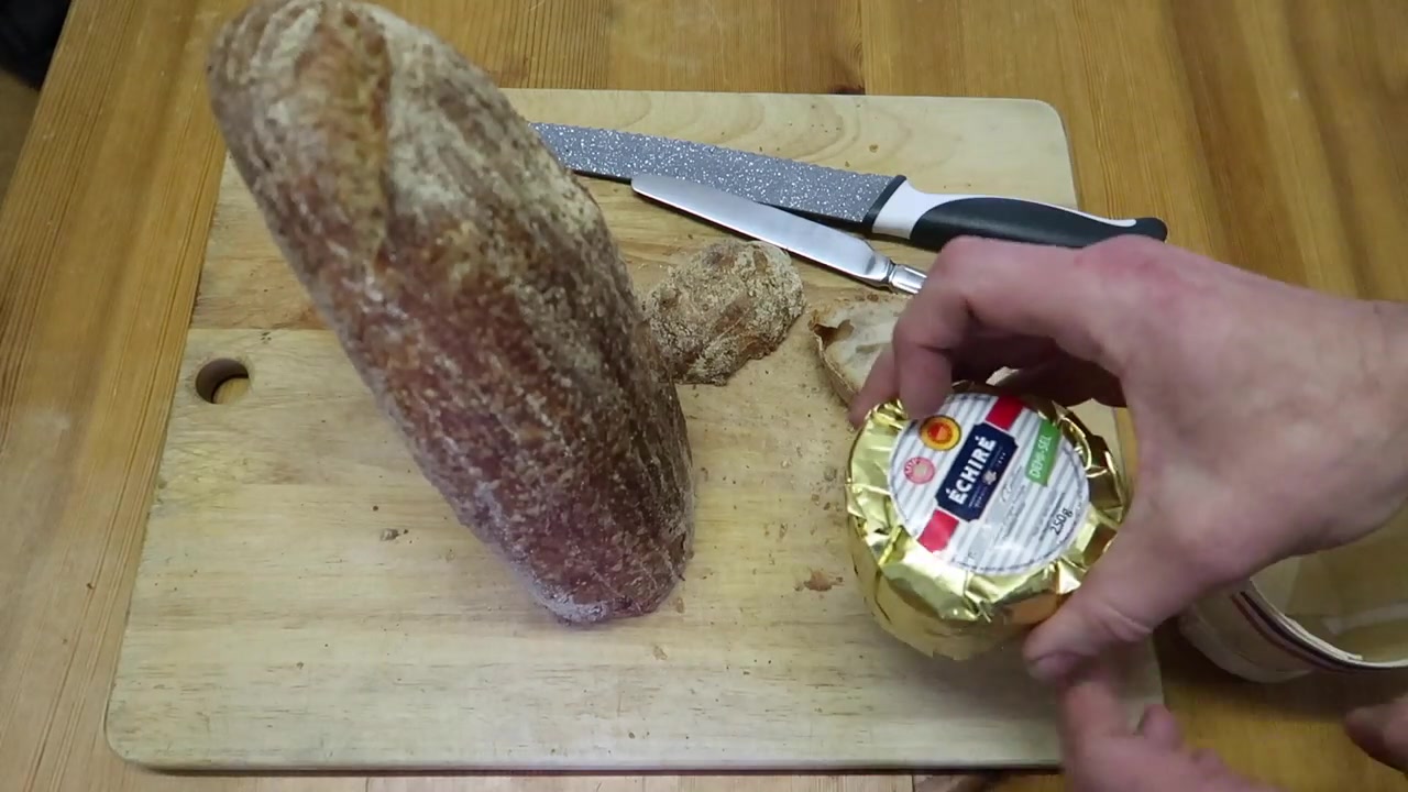 Sourdough bread being prepared with butter for beans on toast