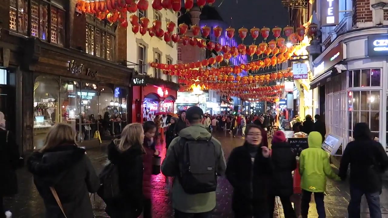 Visitors walking beneath Chinatown’s illuminated decorations.