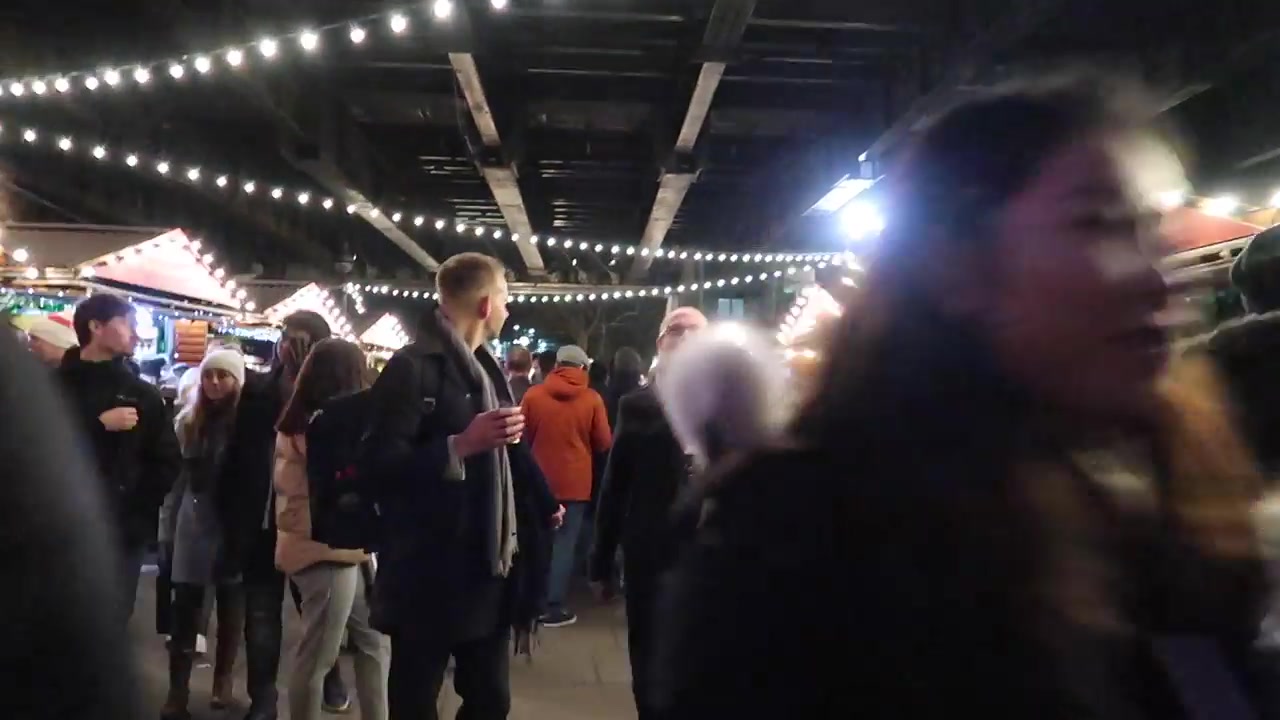 Visitors and stalls at the South Bank Christmas market.