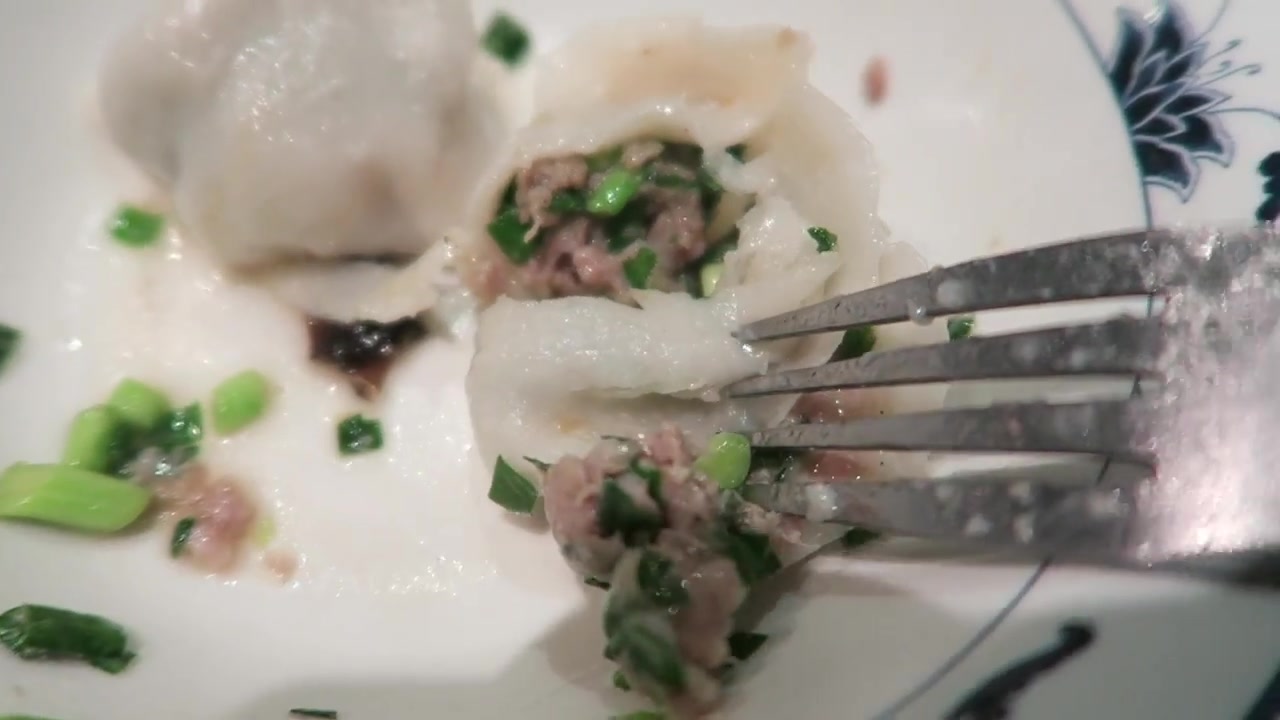 Fresh dumplings being formed by hand in Jen Café’s Chinatown window