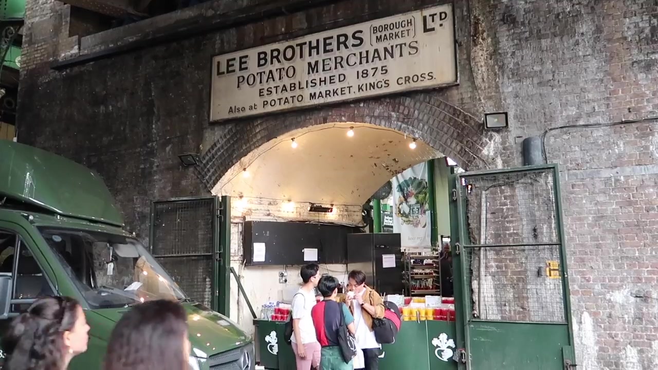 The old Lee Brothers potato merchants sign above a market arch.