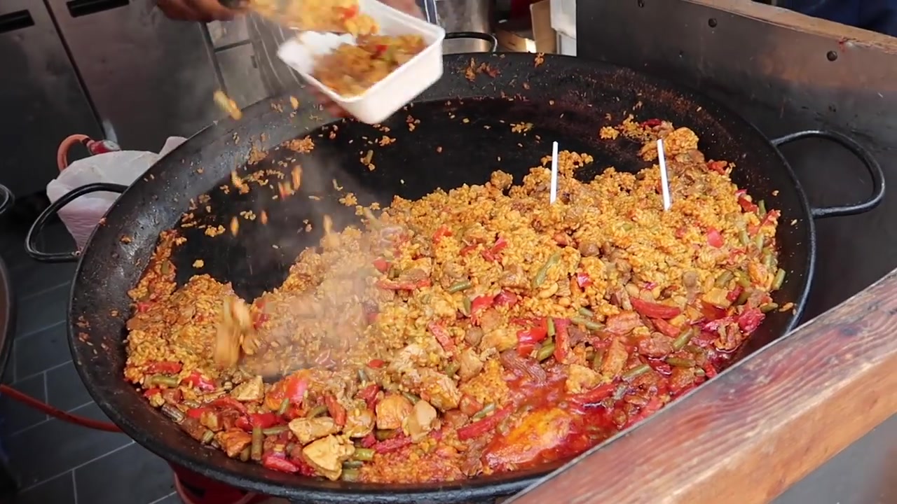 Large pan of paella cooking at a Southbank Centre Food Market stall