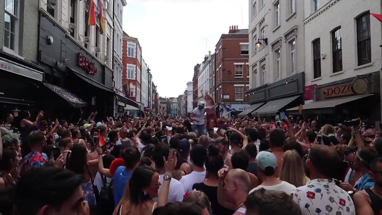 Dense Pride in London crowd filling Old Compton Street in Soho
