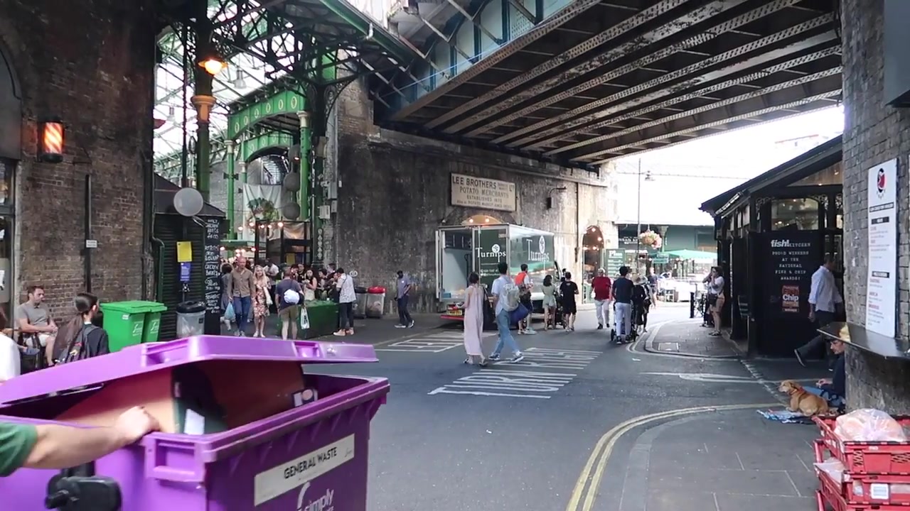 Shoppers walking beneath the railway arches at Borough Market.