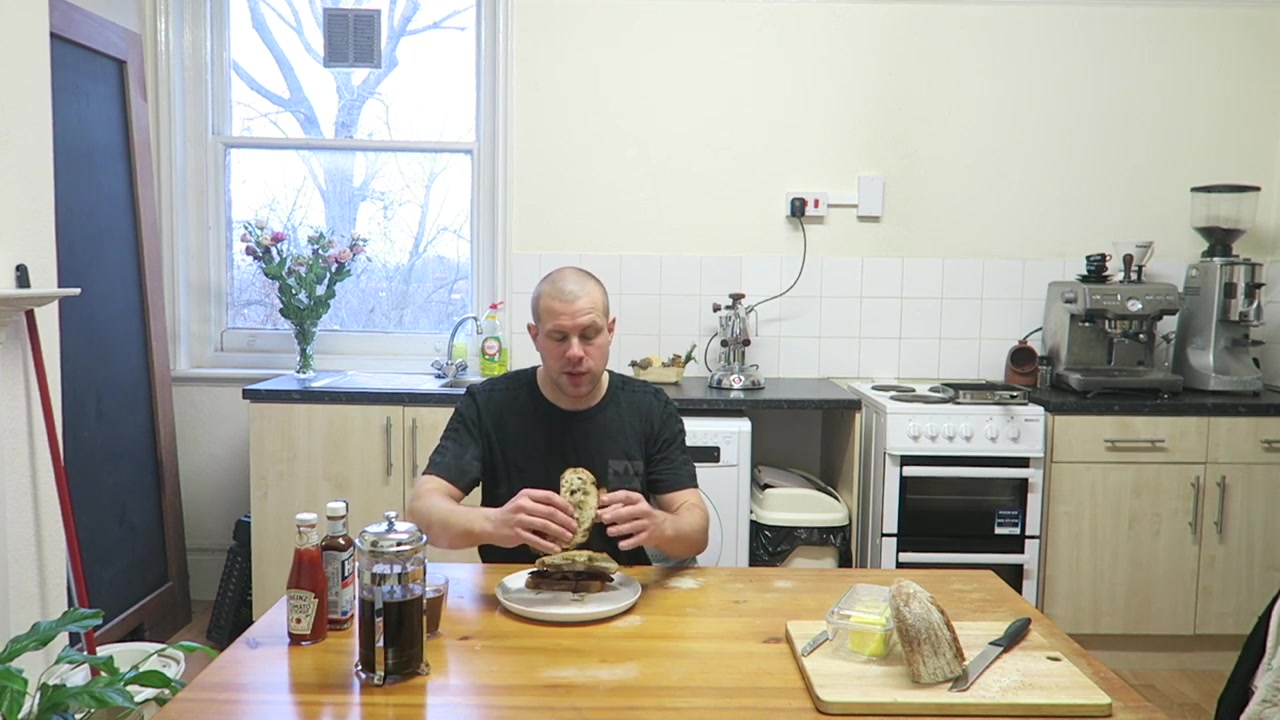 Barry Roberts tasting a homemade double bacon sandwich