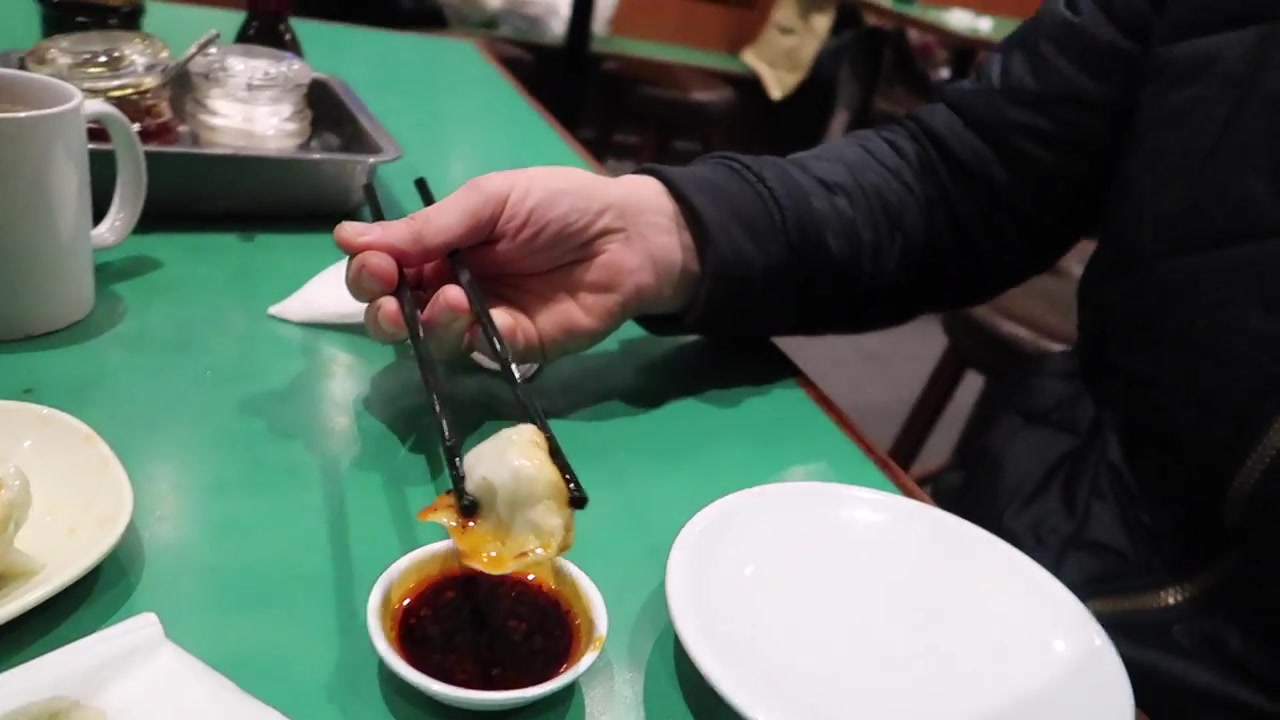 Fresh dumpling dipped in sauce at Jen Cafe Chinatown