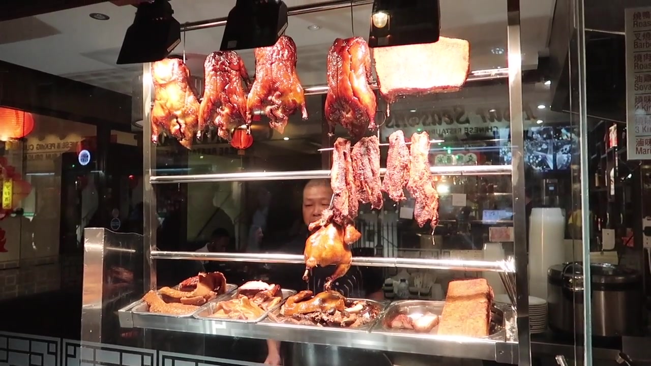 Roast duck and meats hanging in a Chinatown restaurant window