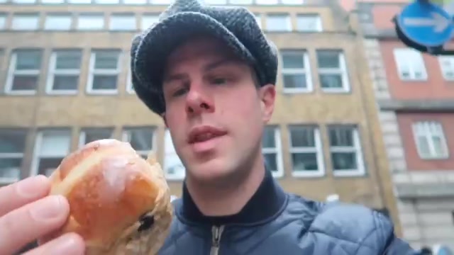 Trying a Bread Ahead hot cross bun on Carnaby Street.