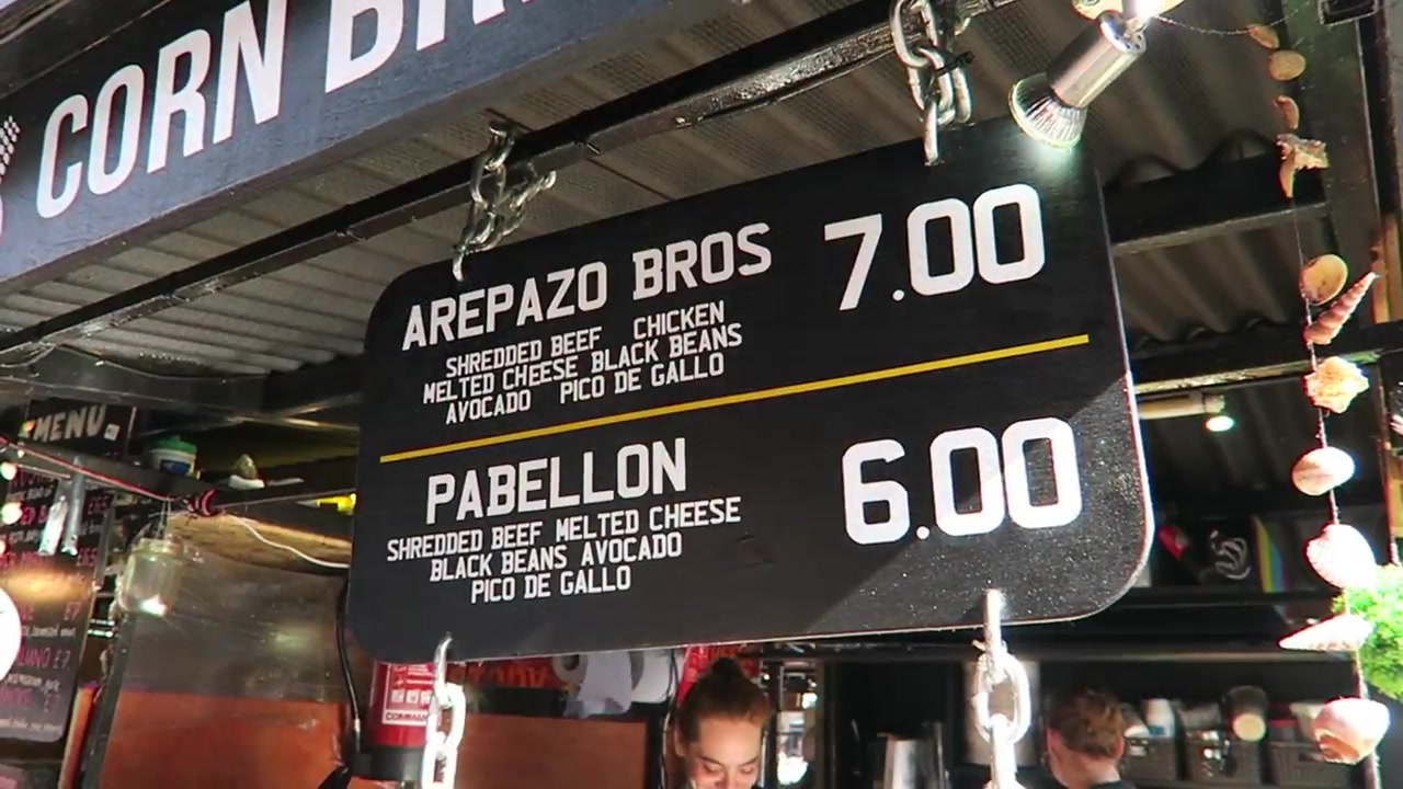 Arepazo Bros menu board showing arepa fillings and 2016 prices