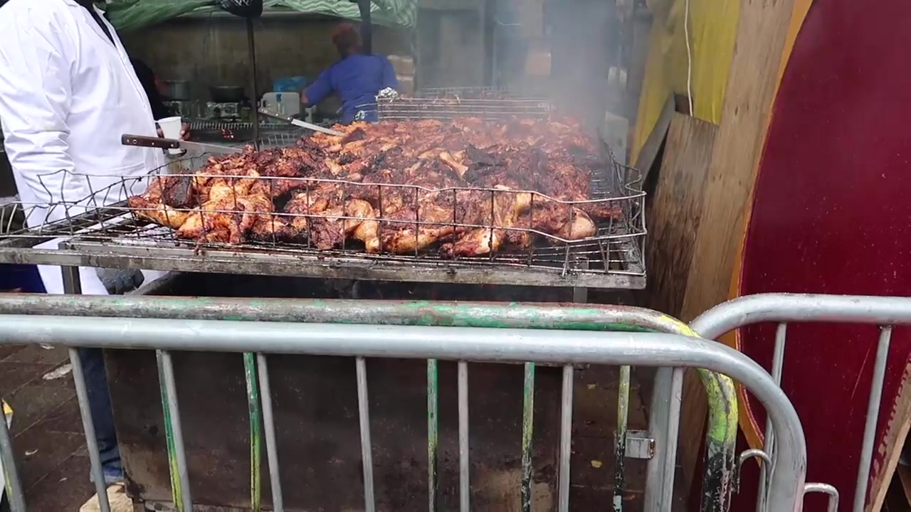 Chicken cooking on a barbecue at Notting Hill Carnival
